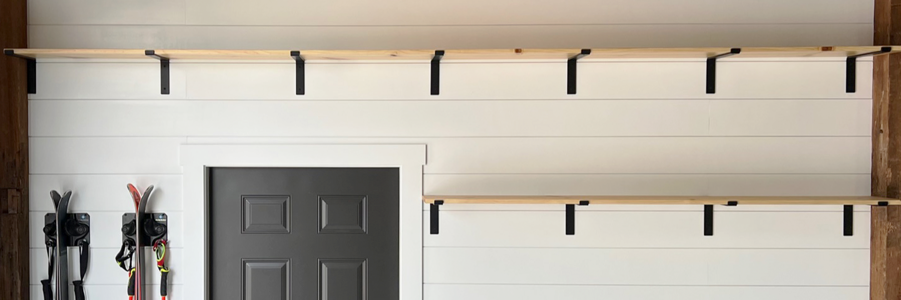 Farmhouse shelf brackets used to support large natural wood shelves in a restored wisconsin dairy barn