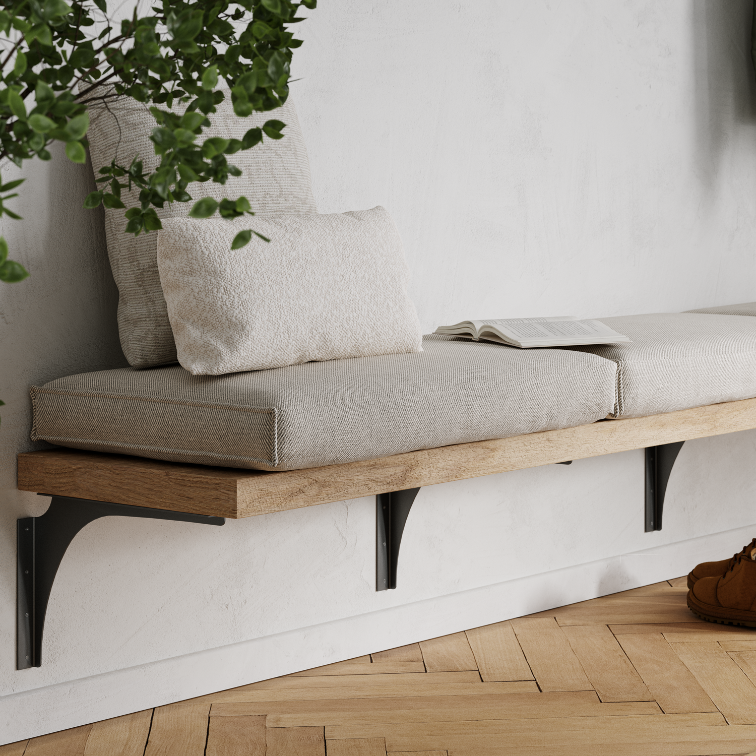 THIS IS A SCENE IMAGE OF OUR STANDARD FRONT MOUNT BENCH BRACKETS IN MATTE BLACK INSTALLED OVER FINISHED DRYWALL. THE BRACKETS ARE HOLDING UP A THICK 2" WOOD BENCH WITH CUSHION SEATS ON TOP IN A FRONT ENTRYWAY.