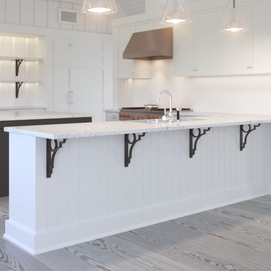 Decorative Iron Corbels supporting a granite countertop overhang on a kitchen peninsula.